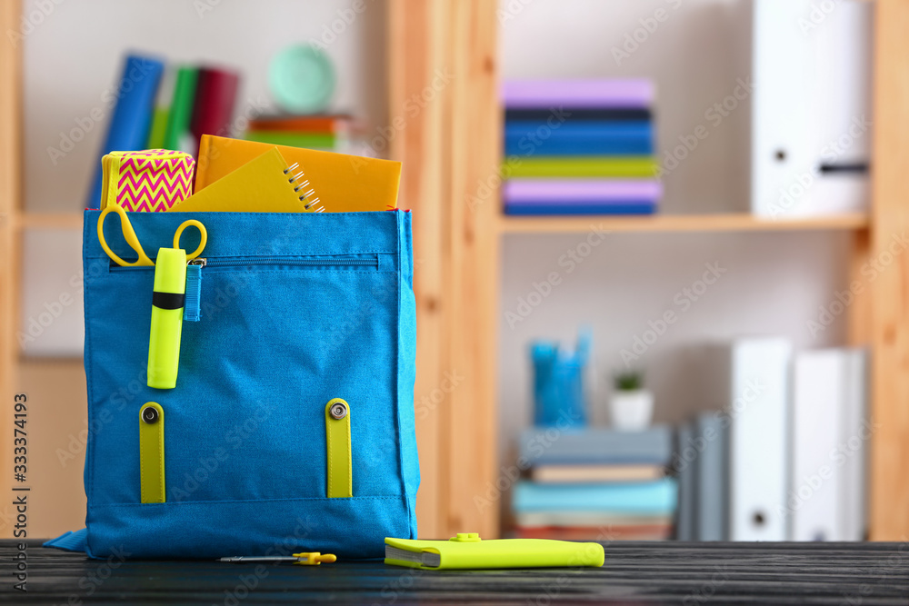 School backpack on table in classroom