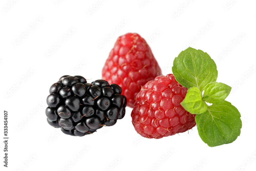 Fresh blackberry and raspberries with mint leaves closeup isolated on white background