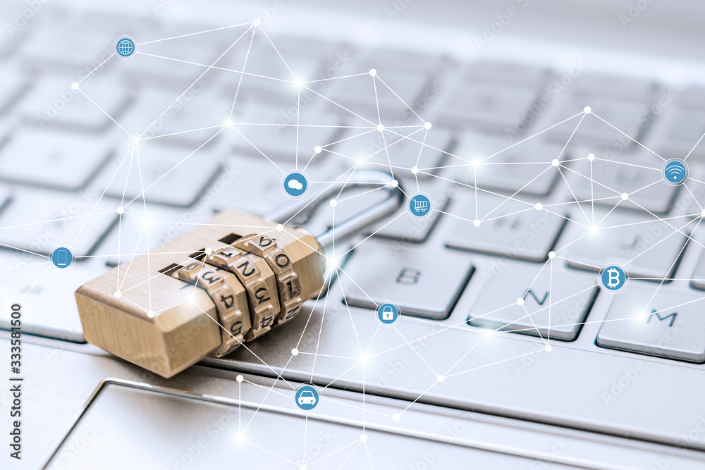 The lock is placed on the computer keyboard to symbolize information security and data interconnecti