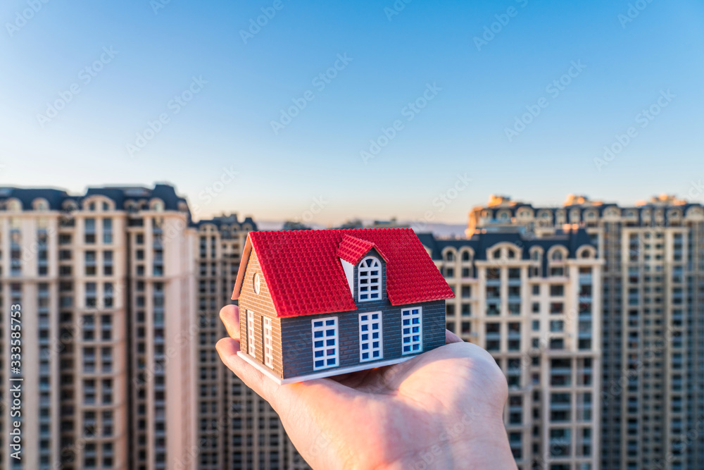 A small house in hand -- concept picture of buying house	