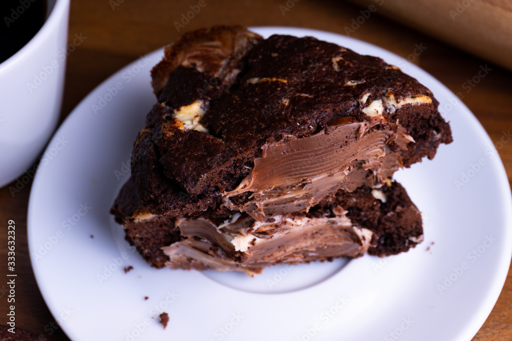 Delicious cookie cakes with chocolate with a cup of coffee on a wooden board with copy space