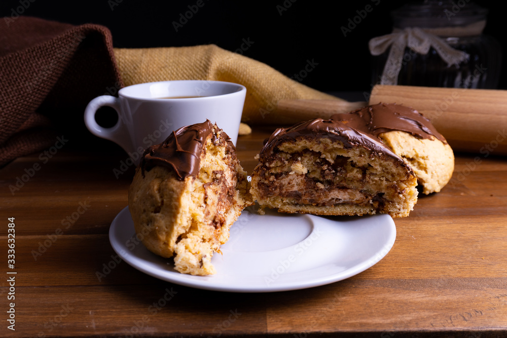 Delicious cookie cakes with chocolate with a cup of coffee on a wooden board with copy space