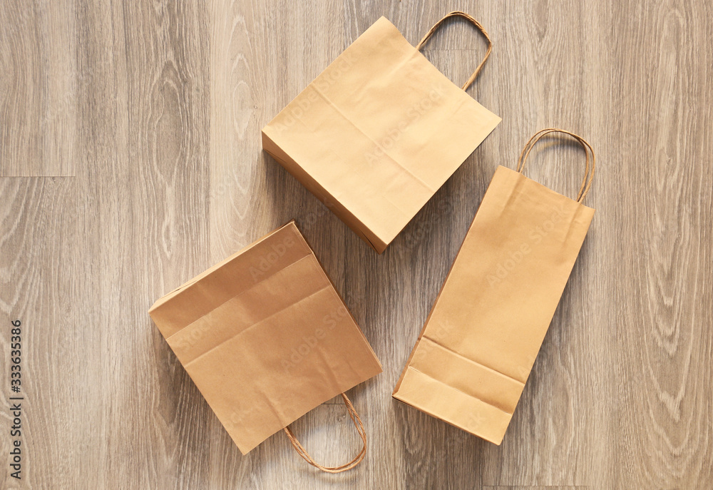 Paper shopping bags on floor, top view