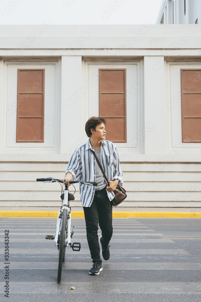 Man looking at his smartphone while walking in the city street