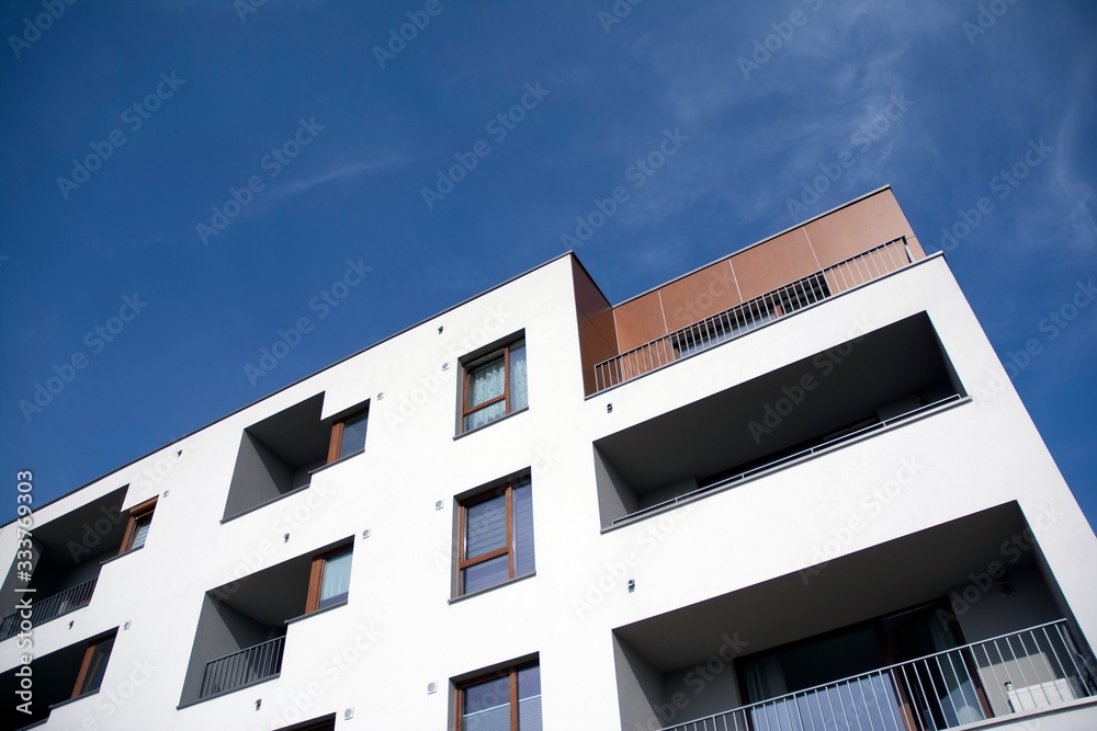 Exterior of new apartment buildings on a blue cloudy sky background. No people. Real estate business