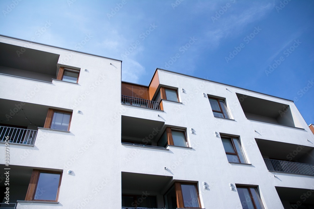 Exterior of new apartment buildings on a blue cloudy sky background. No people. Real estate business