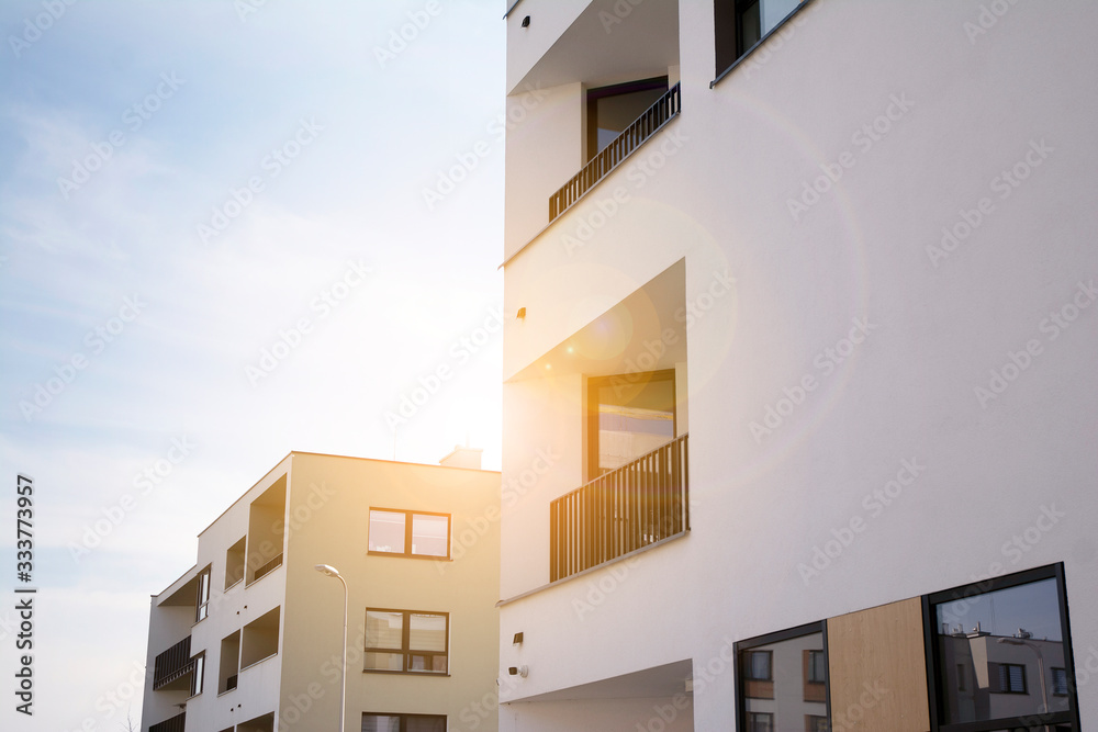 Modern apartment building flat estate concept. Outdoor residential facility at sunset and sunrise.