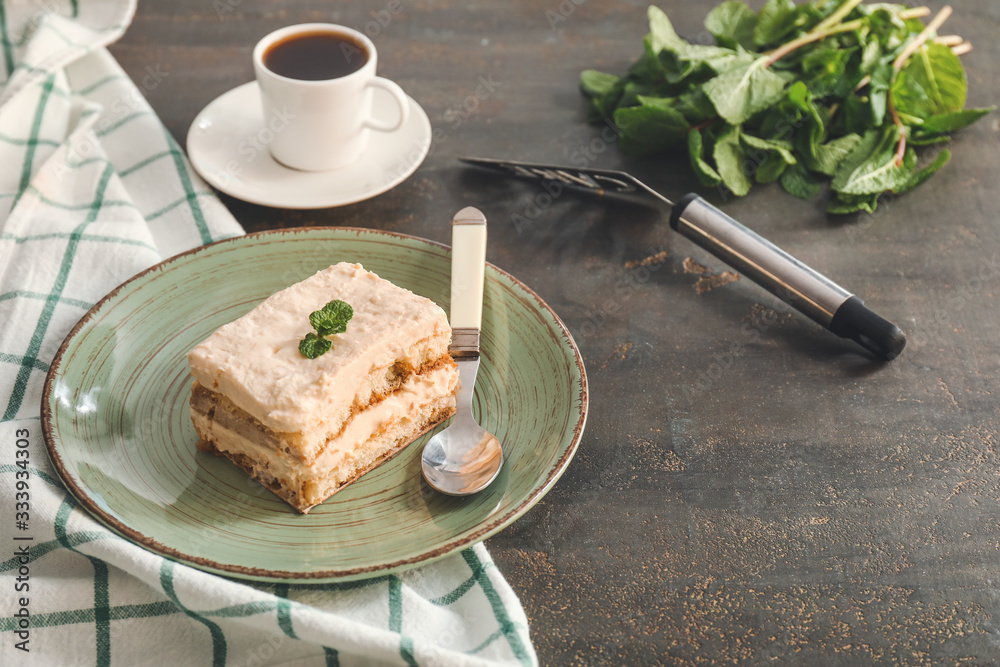 Plate with tasty tiramisu on table