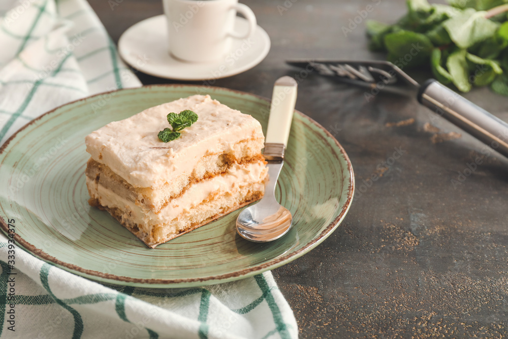 Plate with tasty tiramisu on table