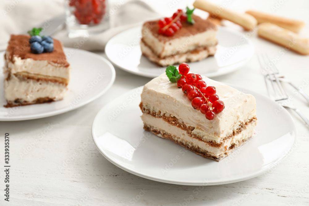 Plate with tasty tiramisu on table