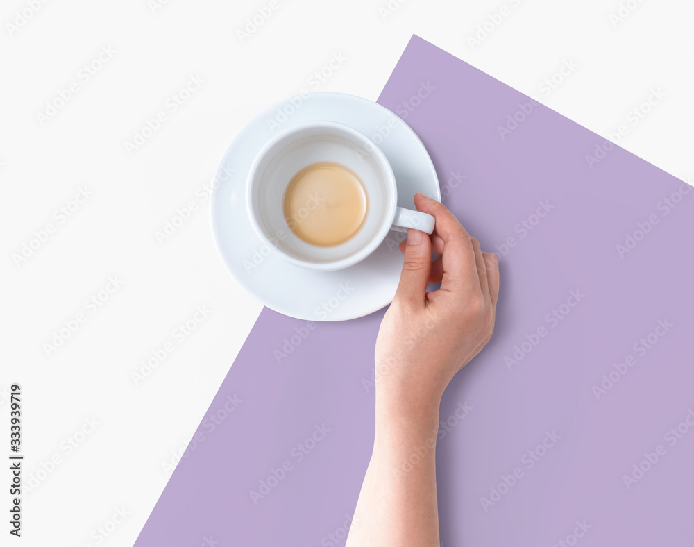 Female hand holding a tea cup overhead view - flat lay