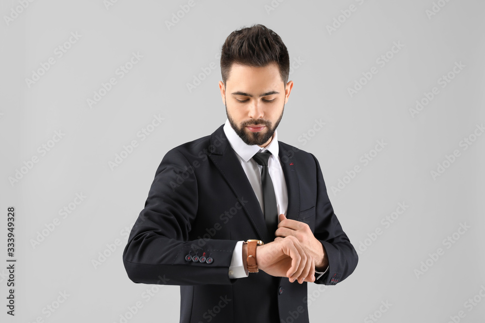 Handsome businessman with healthy hair on light background