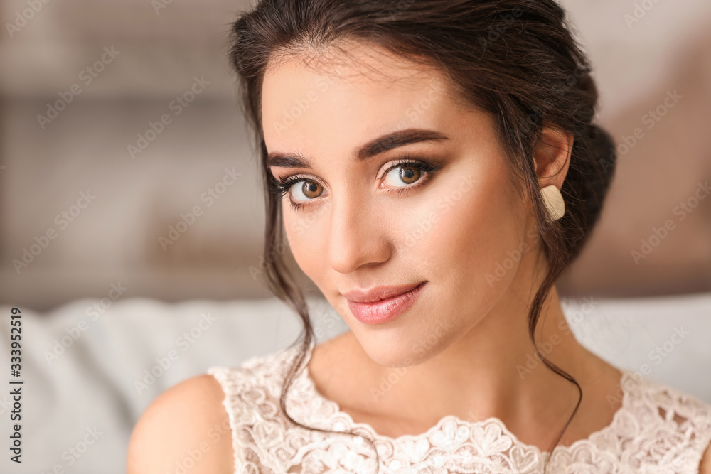 Young bride with beautiful hairdo at home