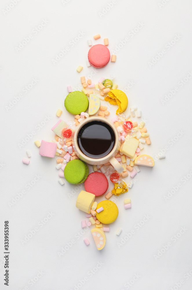 Sweets with cup of coffee on white background