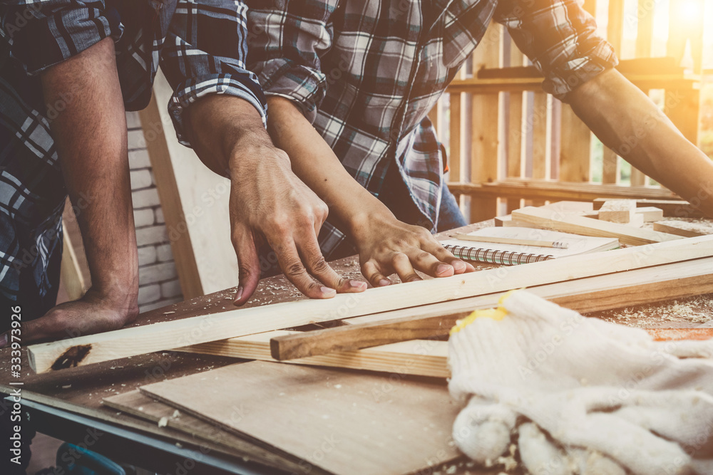 Carpenter working on wood craft at workshop to produce construction material or wooden furniture. Th