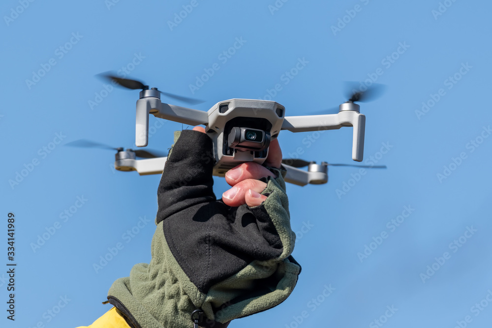 Quadcopter drone while in flight on a sunny day