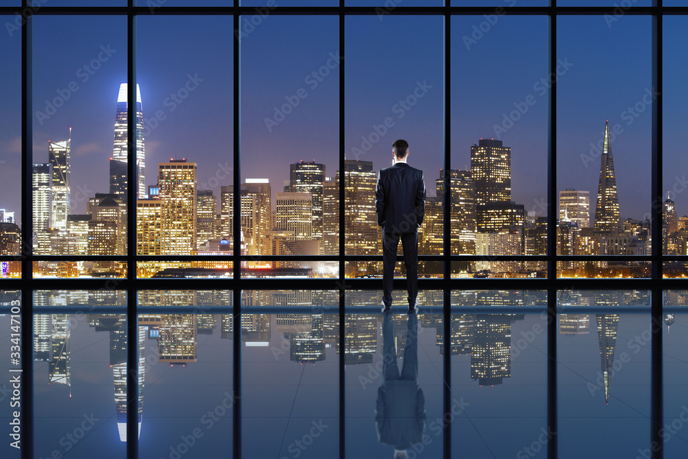 Businessperson looking into distance on rooftop