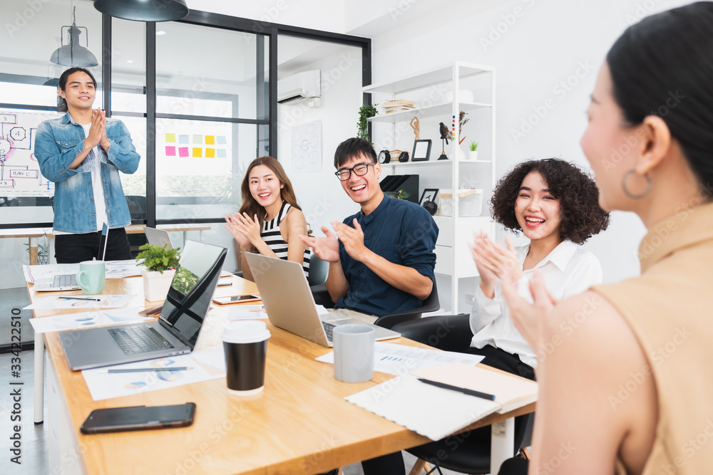 Asian business people clapping hands/applause  while meeting for success in modern office, casual cl