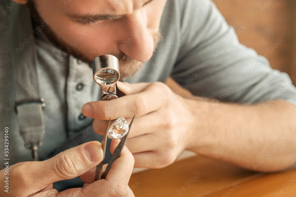 Jeweler examining gemstone in workshop