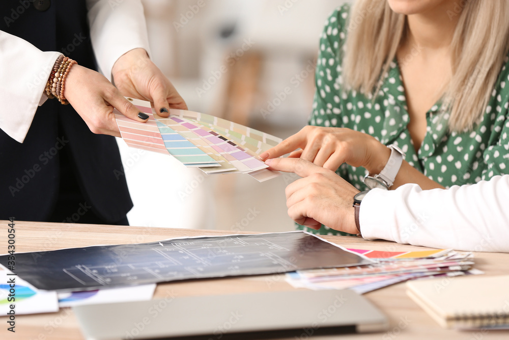 Female interior designer working with couple in office