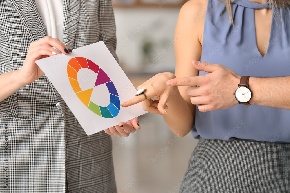 Female interior designer working with couple in office