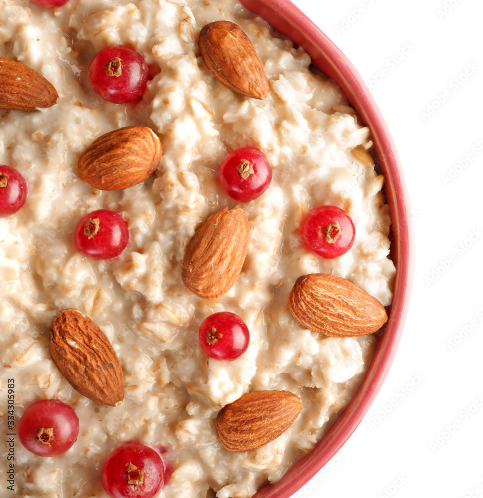 Bowl with tasty sweet oatmeal on white background