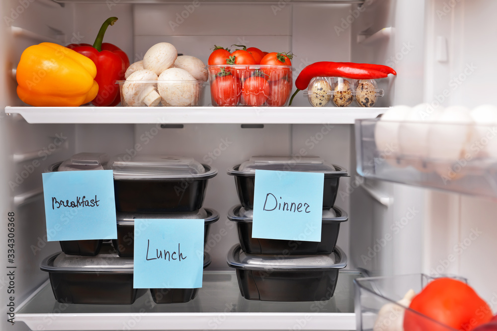 Containers with healthy food on shelf in fridge