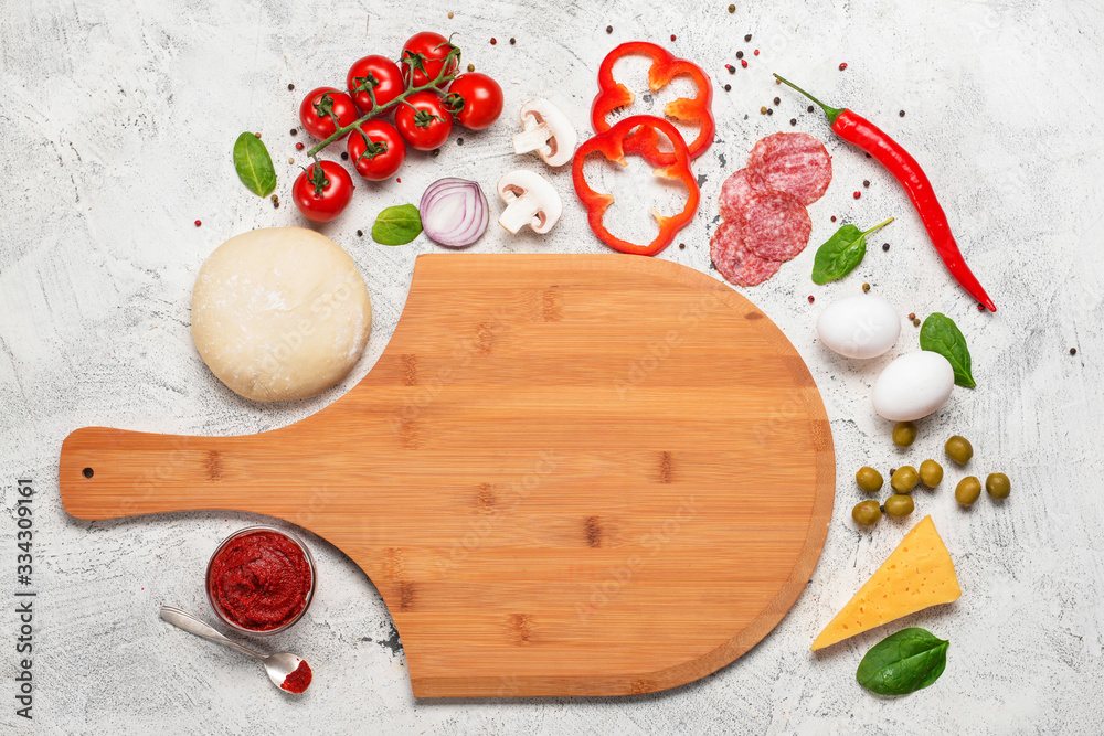 Ingredients for tasty pizza on light background