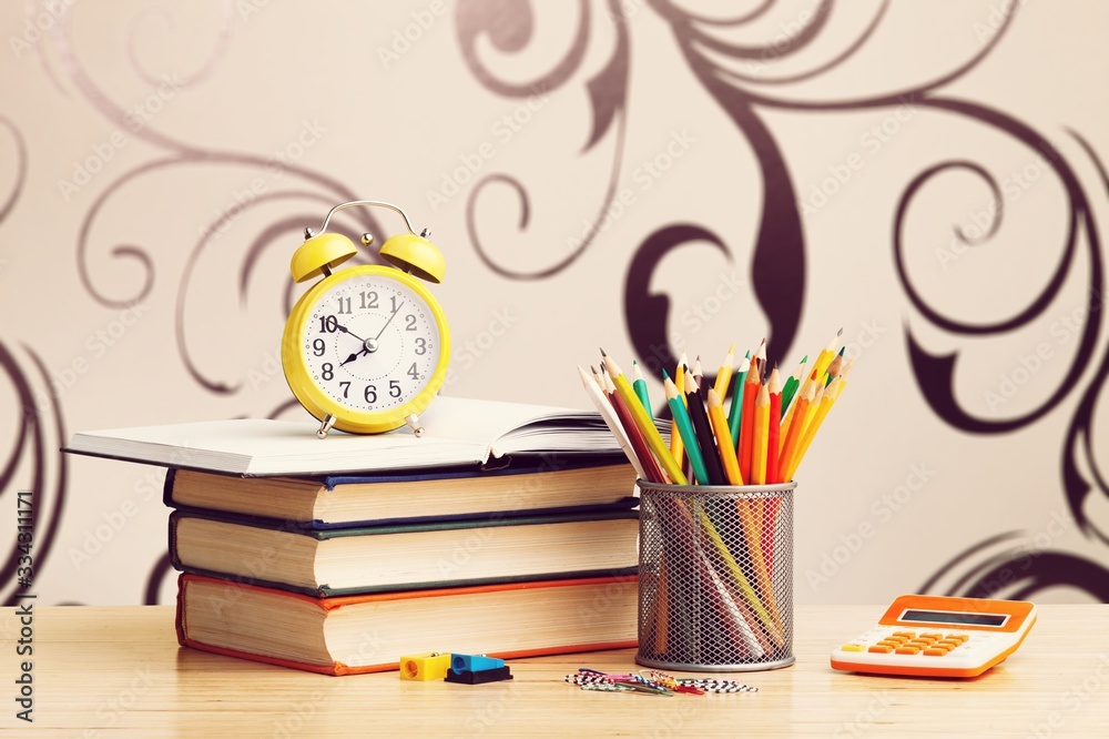 Stack school books with color pencil on desk