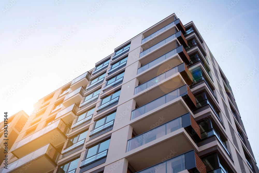 Apartment residential house and home facade architecture and outdoor facilities. Blue sky on the bac