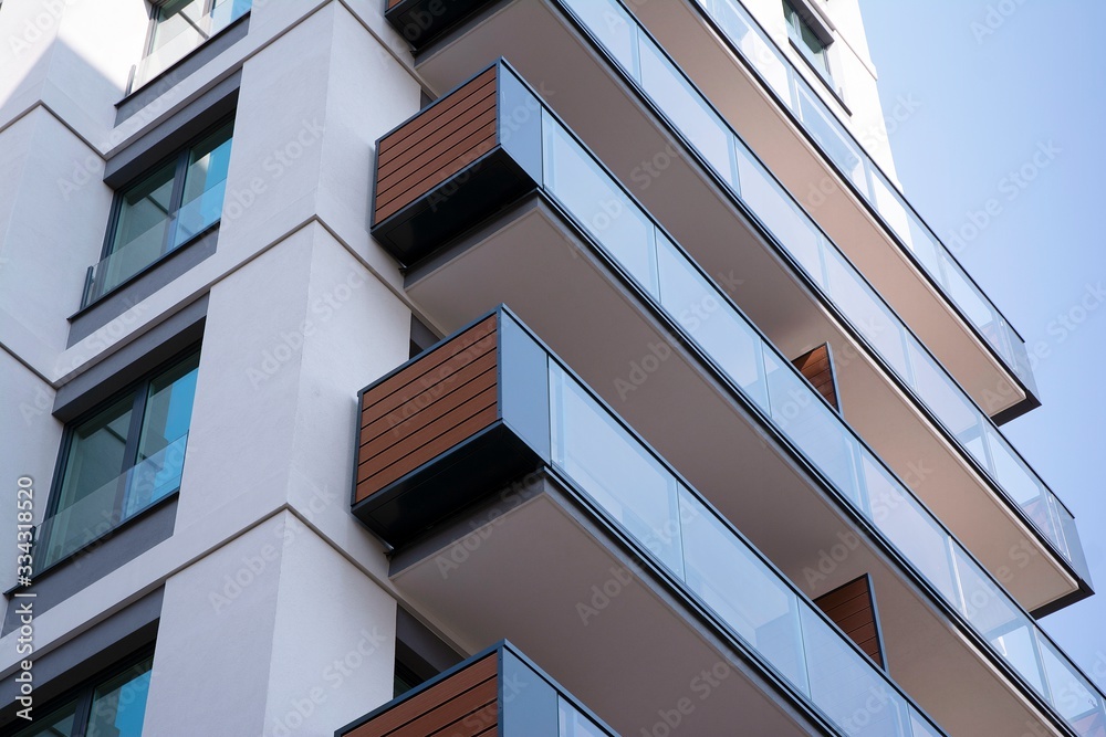 Beautifully designed multistory house with glass facade balconies in city district architecture, lux