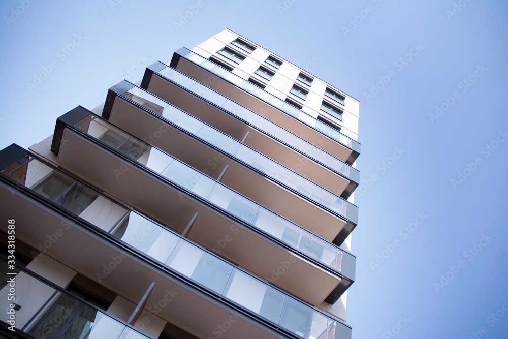 Beautifully designed multistory house with glass facade balconies in city district architecture, lux