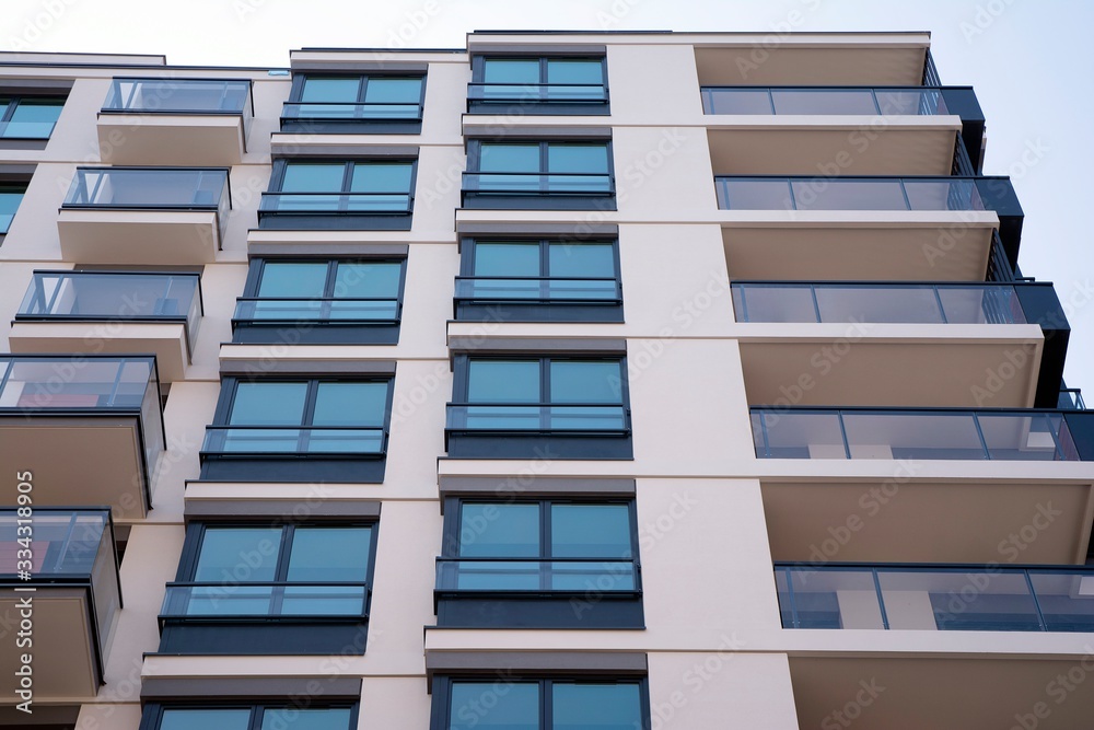 Beautifully designed multistory house with glass facade balconies in city district architecture, lux