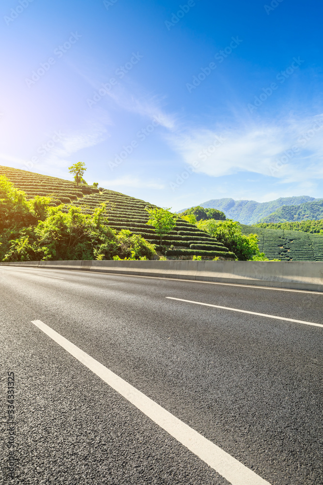 空旷的柏油路和绿茶种植园自然景观。