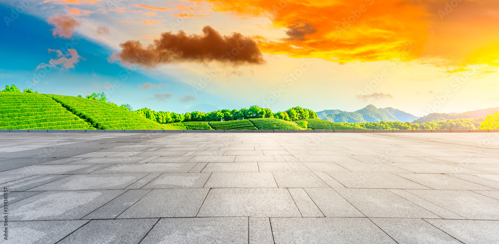 Empty square floor and green tea plantation nature landscape at sunset.