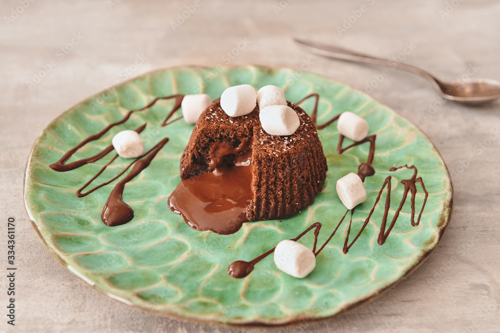 Plate with tasty chocolate cake on grey background