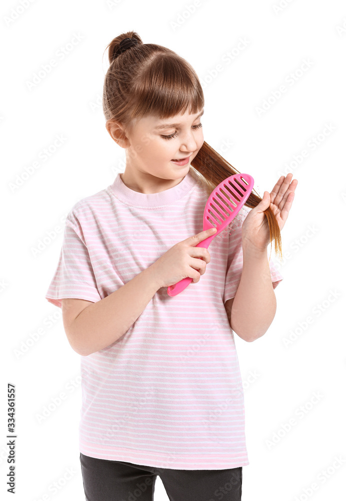 Little girl brushing hair on white background