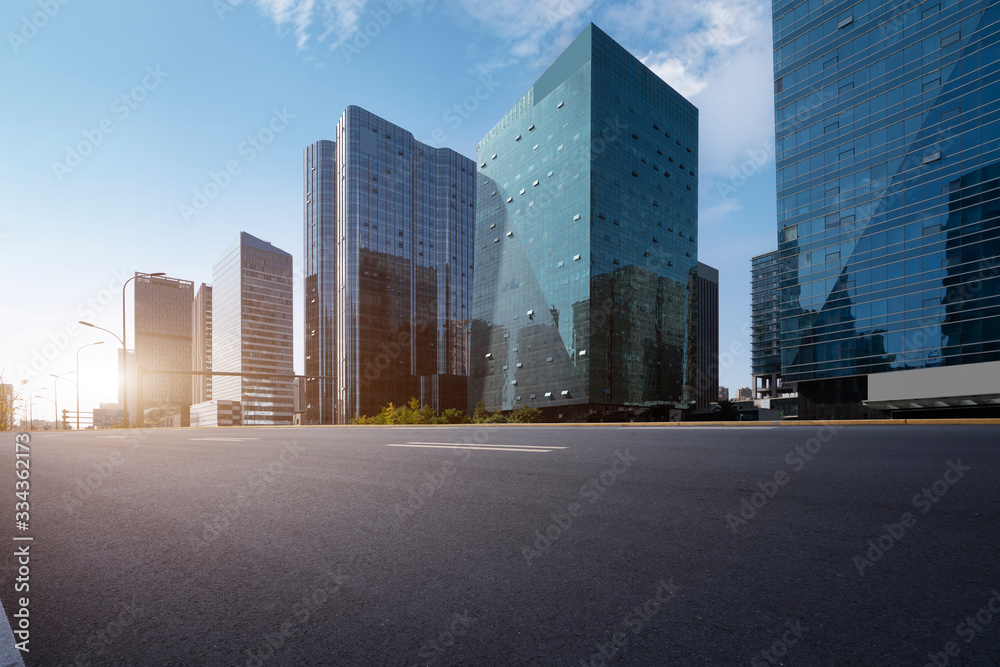 Asphalt road and Ningbo Financial District building office building..