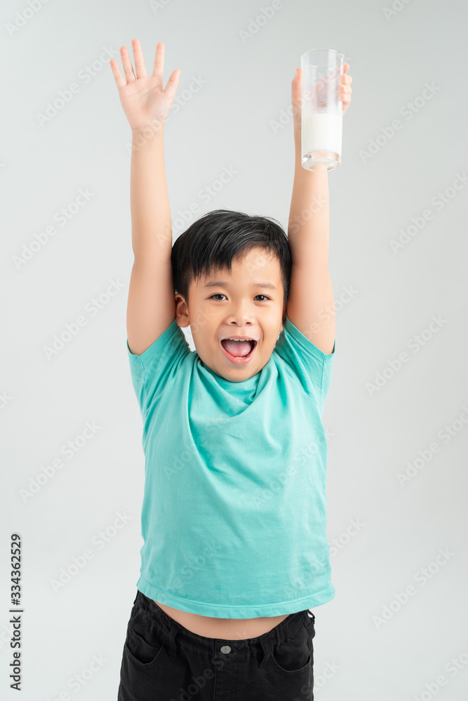 little funny boy with glass of milk