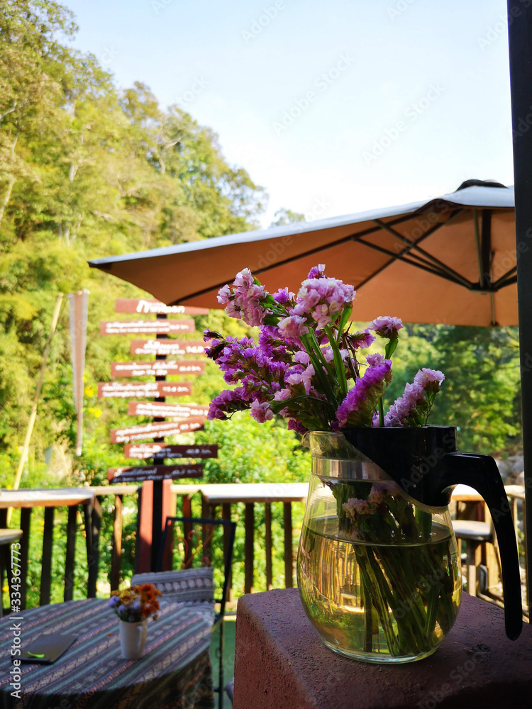 Statice flowers in a glass jar on balcony placed as a beautiful decoration With an unbrella and fore