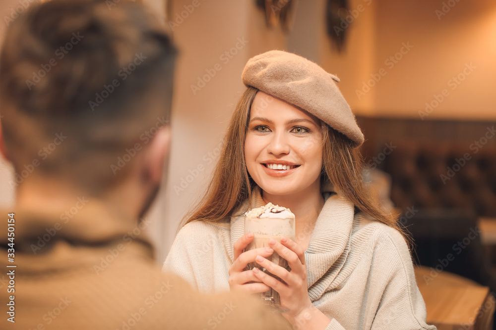 Happy young woman with her boyfriend on romantic date in cafe