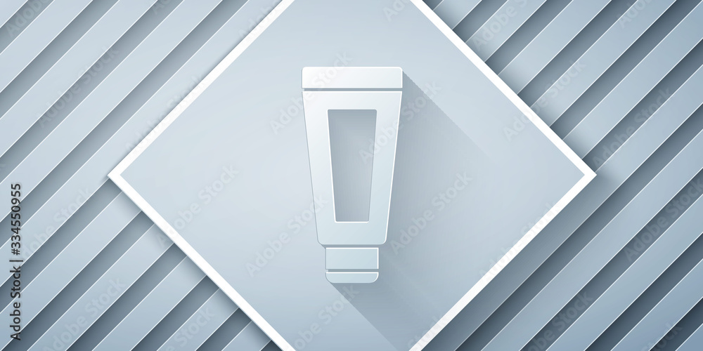 Paper cut Cream or lotion cosmetic tube icon isolated on grey background. Body care products for men