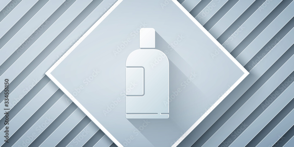 Paper cut Bottle of shampoo icon isolated on grey background. Paper art style. Vector Illustration