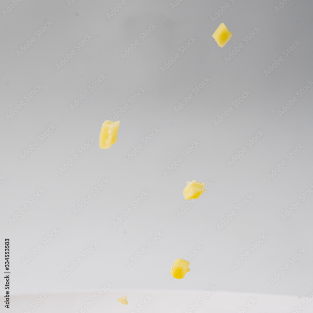 Falling cheese on white background