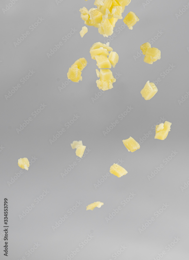 Falling cheese on white background