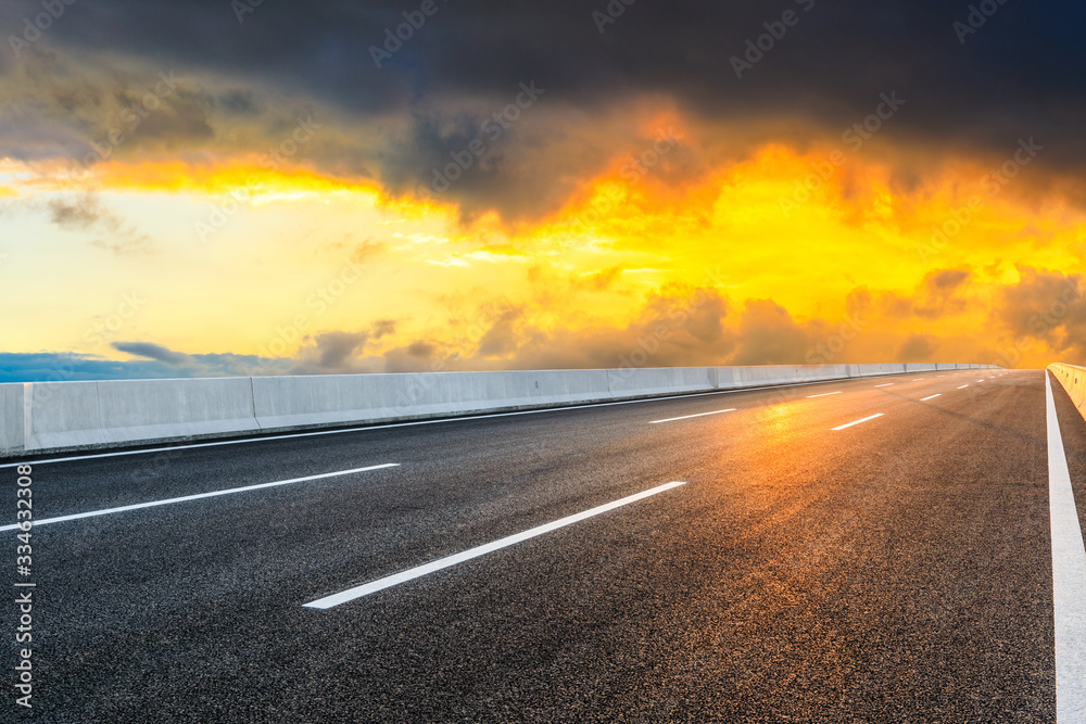 Asphalt highway road and sky sunset clouds landscape.