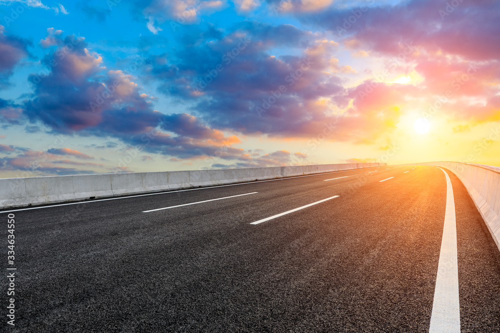 Asphalt highway road and sky sunset clouds landscape.