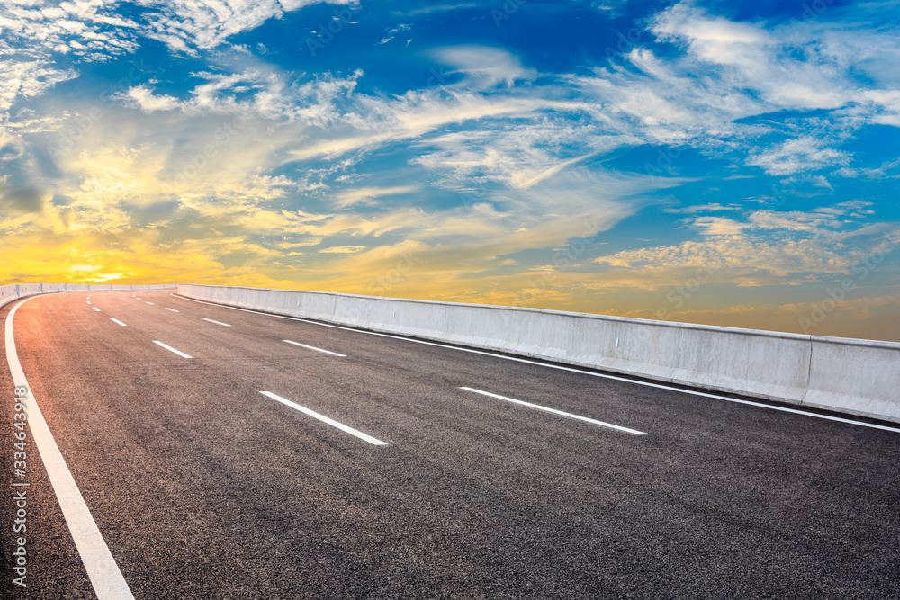 Asphalt highway road and sky sunset clouds landscape.