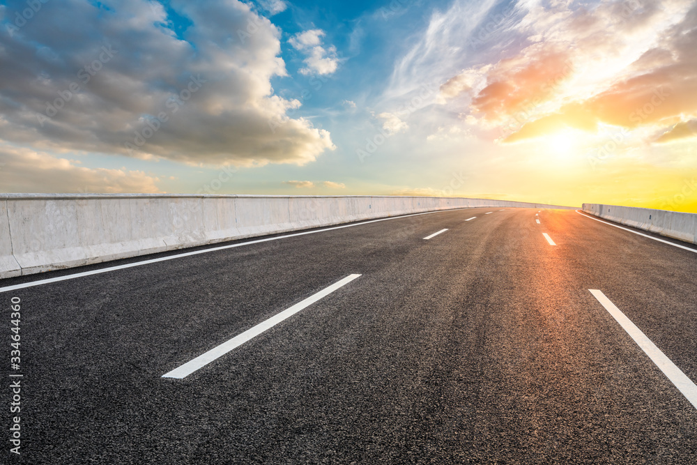 Asphalt highway road and sky sunset clouds landscape.