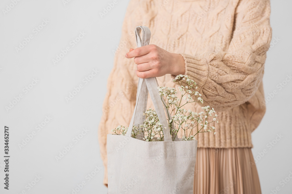 Woman with eco bag on light background